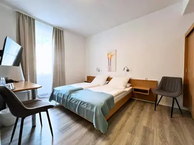 Ein Bett oder Betten in einem Zimmer der Unterkunft City Hotel Neuwied