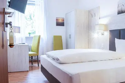 Ein Bett oder Betten in einem Zimmer der Unterkunft Hotel Ehranger Hof