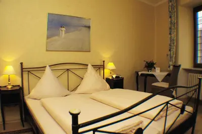 Ein Bett oder Betten in einem Zimmer der Unterkunft Hotel-Restaurant Moselblümchen