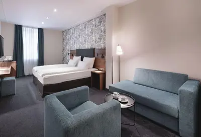 Ein Bett oder Betten in einem Zimmer der Unterkunft Sympathie-Hotel Fürstenhof