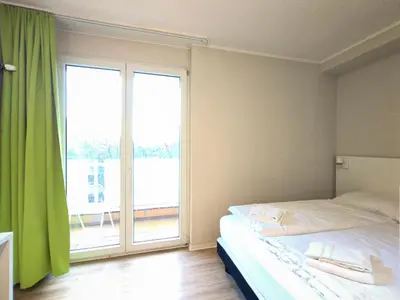 Ein Bett oder Betten in einem Zimmer der Unterkunft Bendorf Hotel by Belvilla