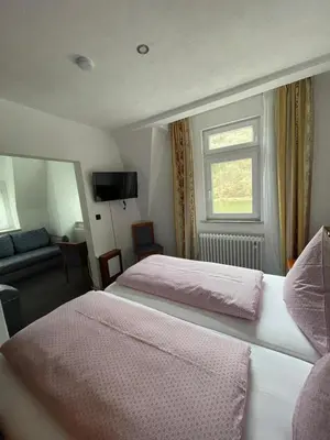 Ein Bett oder Betten in einem Zimmer der Unterkunft Cafe Moselterrasse