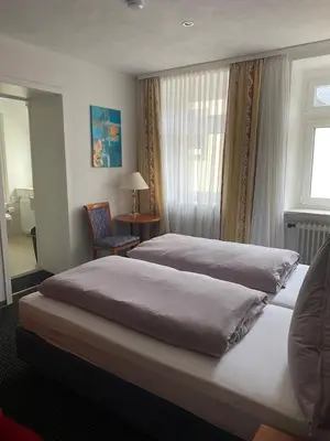 Ein Bett oder Betten in einem Zimmer der Unterkunft Cafe Moselterrasse