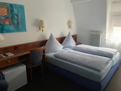 Ein Bett oder Betten in einem Zimmer der Unterkunft Cafe Moselterrasse