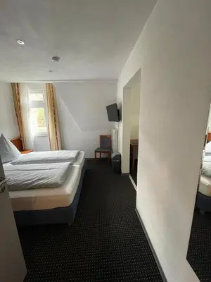 Ein Bett oder Betten in einem Zimmer der Unterkunft Cafe Moselterrasse
