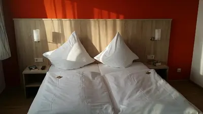 Ein Bett oder Betten in einem Zimmer der Unterkunft Hotel Rheinkrone