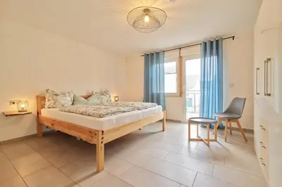 Ein Bett oder Betten in einem Zimmer der Unterkunft Ferienwohnungen Weingut und Vinothek Regnery