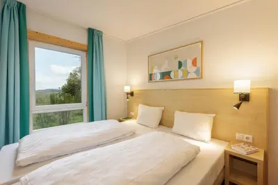 Ein Bett oder Betten in einem Zimmer der Unterkunft Center Parcs Bostalsee Saarland