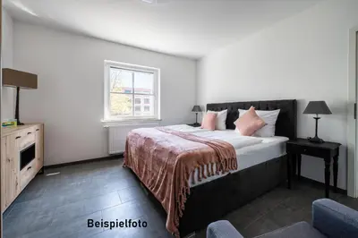 Ein Bett oder Betten in einem Zimmer der Unterkunft Nells Park Hotel Ferienwohnungen