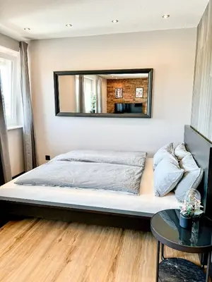 Ein Bett oder Betten in einem Zimmer der Unterkunft JUPAS - Premium Apartments Trier