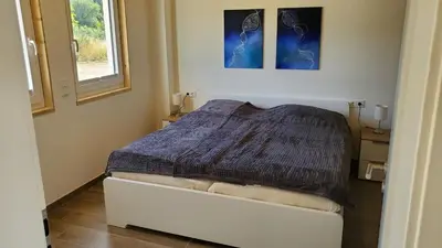 Ein Bett oder Betten in einem Zimmer der Unterkunft Ferienhäuser Prüm