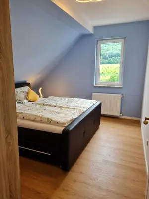 Ein Bett oder Betten in einem Zimmer der Unterkunft Buergerhaus Zeltingen Fewo