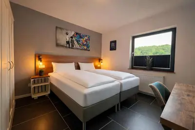 Ein Bett oder Betten in einem Zimmer der Unterkunft JUNIPRO Apartments & Rooms