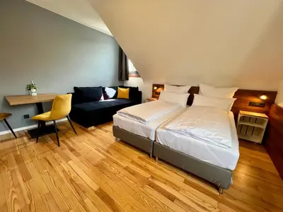 Ein Bett oder Betten in einem Zimmer der Unterkunft JUNIPRO Hotel Schinderhannes