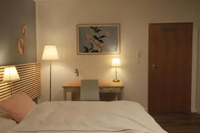 Ein Bett oder Betten in einem Zimmer der Unterkunft Zimmer AsiaDreieck Pension