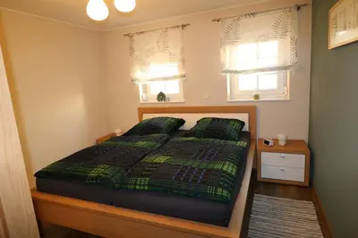 Ein Bett oder Betten in einem Zimmer der Unterkunft Ferienwohnung Am Pfaffenderbach