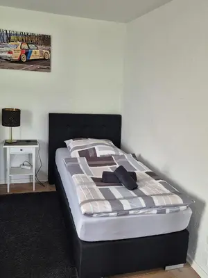 Ein Bett oder Betten in einem Zimmer der Unterkunft Hinter'm Mäuerchen
