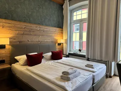 Ein Bett oder Betten in einem Zimmer der Unterkunft Nostalgie Altstadthotel Kornpforte
