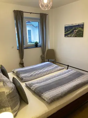 Ein Bett oder Betten in einem Zimmer der Unterkunft Ferienwohnung Am Hochkelberg
